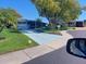 Charming home featuring a painted driveway, mature tree, and well-maintained landscaping at 46 Washington Ct # 28, Palm Harbor, FL 34684