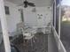 Relaxing outdoor screened patio with comfortable seating and a ceiling fan for warm days at 46 Washington Ct # 28, Palm Harbor, FL 34684