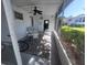 Relaxing screened-in porch with ceiling fan, table, and chairs at 46 Washington Ct # 28, Palm Harbor, FL 34684