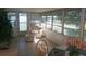 Inviting sunroom with tiled floor, large windows, and cozy seating area with natural light at 46 Washington Ct # 28, Palm Harbor, FL 34684