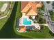 Stunning aerial view of pool, golf course, and building featuring lush landscaping and tranquil water features at 4802 Raintree Street E Cir, Bradenton, FL 34203