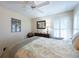 Cozy bedroom with carpet, fan, bed, and plenty of natural light from the windows at 4802 Raintree Street E Cir, Bradenton, FL 34203