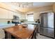 Charming kitchen featuring white cabinets and stainless steel refrigerator at 4802 Raintree Street E Cir, Bradenton, FL 34203