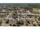 Wide aerial shot showcasing a residential area with numerous homes, streets, and pockets of green spaces, with a clear blue sky at 5232 Kirkwood Ave, Spring Hill, FL 34608
