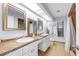 Bright bathroom featuring dual sinks, granite counters, tile floors and tiled shower at 5232 Kirkwood Ave, Spring Hill, FL 34608