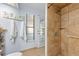 Bathroom featuring a tiled walk-in shower and a door to the outdoor spaces at 5232 Kirkwood Ave, Spring Hill, FL 34608