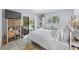 Bedroom with queen bed, white bedding, built-in shelves, and slider to the pool at 5232 Kirkwood Ave, Spring Hill, FL 34608