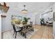 Bright dining room featuring stylish furnishings, natural light, and open access to the living area at 5232 Kirkwood Ave, Spring Hill, FL 34608