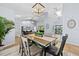 Bright dining room with modern light fixture and view into the living room at 5232 Kirkwood Ave, Spring Hill, FL 34608