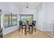 Bright kitchen nook with table and chairs, offering views of the screened-in pool at 5232 Kirkwood Ave, Spring Hill, FL 34608
