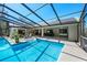 Beautiful pool area with a screened enclosure, covered patio, and views of the home's exterior and backyard at 5232 Kirkwood Ave, Spring Hill, FL 34608