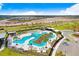 Overhead view of a modern community pool area with palm trees, lounging areas, and shade structures at 5461 Elmview Xing, Wesley Chapel, FL 33545