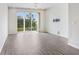 Minimalist living room featuring sliding glass doors and laminate flooring and ceiling fan at 5461 Elmview Xing, Wesley Chapel, FL 33545