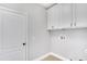 Laundry room with white walls, cabinets, a door, and hookups at 6019 Gannetdale Dr, Lithia, FL 33547