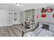 Bedroom featuring wood-look floors, ample natural light, closet, and space for creative design at 6208 Florida W Cir, Apollo Beach, FL 33572