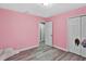 Cozy bedroom with ample natural light, wood-look floors, and a closet for storage at 6208 Florida W Cir, Apollo Beach, FL 33572