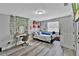 Bedroom with wood-look floors and closet offers a flexible living space or home office at 6208 Florida W Cir, Apollo Beach, FL 33572