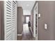 Hallway view with hardwood floors leading to the home's open-concept living area, and featuring ample storage at 6208 Florida W Cir, Apollo Beach, FL 33572