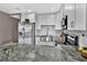 Modern kitchen with stainless steel appliances, white cabinets and a granite countertop at 6208 Florida W Cir, Apollo Beach, FL 33572