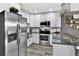 Modern kitchen with stainless steel appliances, white cabinets and a large island at 6208 Florida W Cir, Apollo Beach, FL 33572