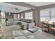 Open-concept living room with a large gray sofa and stylish decor at 6208 Florida W Cir, Apollo Beach, FL 33572