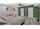 Stylish main bedroom with decorative green accent wall and hanging macrame at 6208 Florida W Cir, Apollo Beach, FL 33572