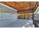 Covered patio ideal for outdoor entertainment, featuring wood ceilings and views of the fenced backyard at 6208 Florida W Cir, Apollo Beach, FL 33572