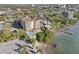 Aerial view of a waterfront building with a pool, dock and waterfront access to the beach and water at 700 N Osceola Ave # 504, Clearwater, FL 33755
