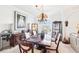 Elegant dining room boasts wood table and chairs, stylish light fixture, wine rack, and built-in wood cabinets at 700 N Osceola Ave # 504, Clearwater, FL 33755
