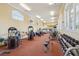 Well-equipped gym with various exercise machines, free weights, mirrors, and natural light at 700 N Osceola Ave # 504, Clearwater, FL 33755