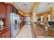 Open-concept kitchen with stainless steel appliances, wood cabinets, granite countertop and island bar seating at 700 N Osceola Ave # 504, Clearwater, FL 33755