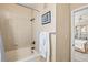 Well-lit bathroom featuring a shower-tub combination and access to the bedroom at 10115 Courtney Palms Blvd # 202, Tampa, FL 33619