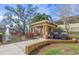 Outdoor grilling area featuring built-in grills, a shaded gazebo, and a serene pond view at 10115 Courtney Palms Blvd # 202, Tampa, FL 33619
