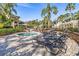 Relaxing hot tub area with lounge chairs and lush landscaping for a tranquil outdoor experience at 10115 Courtney Palms Blvd # 202, Tampa, FL 33619