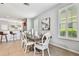 Open dining room showcases a stylish table setting and seamlessly connects to the adjacent kitchen and bar area at 10947 Cory Lake Dr, Tampa, FL 33647
