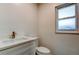 Modern bathroom features white vanity, toilet, and window at 11492 60Th Lane, Pinellas Park, FL 33782