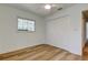 Bedroom with wood-look floors, bright natural light from the window, and a closet at 11492 60Th Lane, Pinellas Park, FL 33782