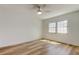 A bedroom showing hardwood floors, ceiling fan, and a large window at 11492 60Th Lane, Pinellas Park, FL 33782