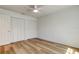 Bright bedroom features light wood flooring, a ceiling fan and a closet with bifold doors at 11492 60Th Lane, Pinellas Park, FL 33782