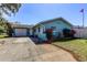 Beautiful home exterior showcasing a well-maintained yard, long driveway and manicured landscaping at 11492 60Th Lane, Pinellas Park, FL 33782