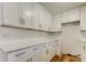 Updated kitchen showcases new white cabinets, counters, and stainless steel hardware at 11492 60Th Lane, Pinellas Park, FL 33782