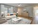 Staged living room with ample seating, large windows, and hardwood flooring at 11492 60Th Lane, Pinellas Park, FL 33782