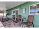 View of the covered patio with a seating area and an outdoor table, perfect for relaxing at 11492 60Th Lane, Pinellas Park, FL 33782