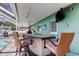 Outdoor bar with seating and a television for outdoor entertainment near the pool area at 11492 60Th Lane, Pinellas Park, FL 33782