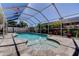 Sparkling pool surrounded by a screened enclosure, and adorned with lush landscaping for ultimate privacy and relaxation at 11492 60Th Lane, Pinellas Park, FL 33782