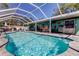 Full view of sparkling swimming pool and patio area complete with outdoor kitchen and seating at 11492 60Th Lane, Pinellas Park, FL 33782