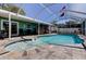 Beautiful in-ground swimming pool with a unique design, fountain, and spacious patio area at 11492 60Th Lane, Pinellas Park, FL 33782