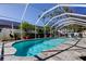 Refreshing screened pool and stone patio complemented by lush landscaping, creating a serene and private backyard retreat at 11492 60Th Lane, Pinellas Park, FL 33782