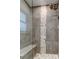Modern shower features neutral tile, glass door, shower seat, and designer tile insert at 11492 60Th Lane, Pinellas Park, FL 33782