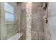 Modern shower features neutral tile, a glass door, and shower seat at 11492 60Th Lane, Pinellas Park, FL 33782